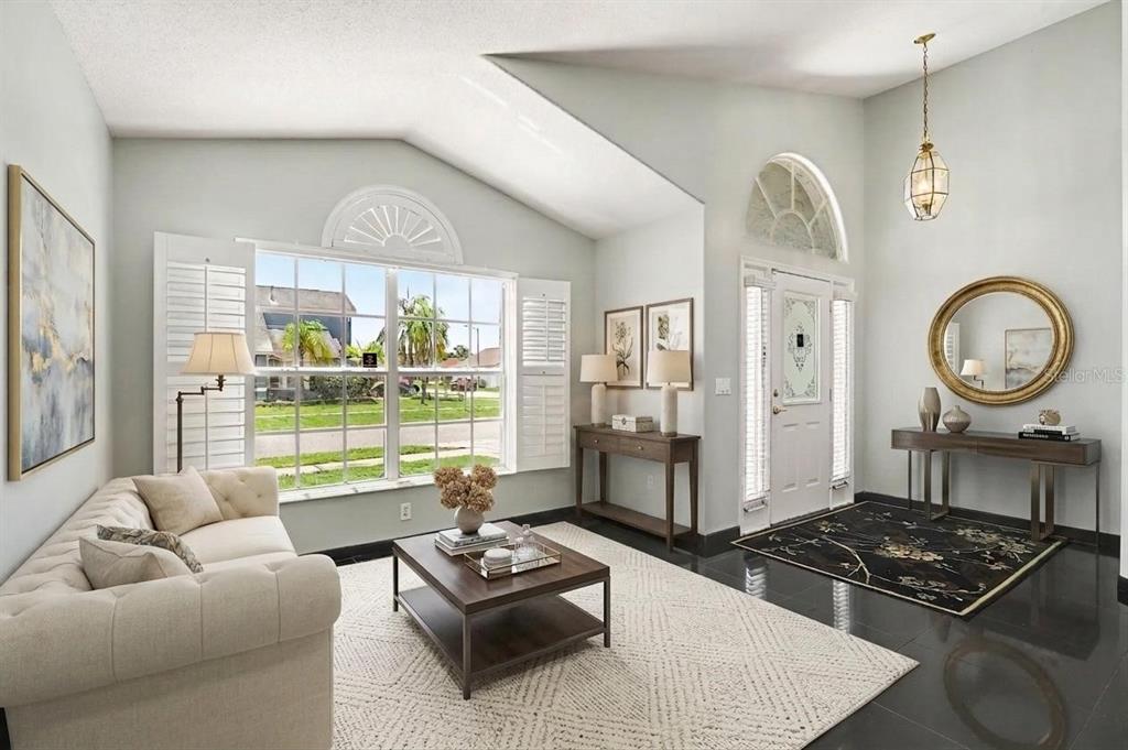 A living room with vaulted ceilings, a large window, and dark tile flooring — 3342 CRYSTAL CREEK BOULEVARD, ORLANDO, FL