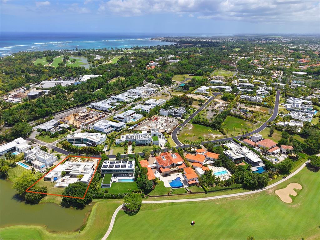A modern house exterior features a flat roof, palm trees, and a paved entryway — 11 GOLF VIEW DRIVE, DORADO, PR