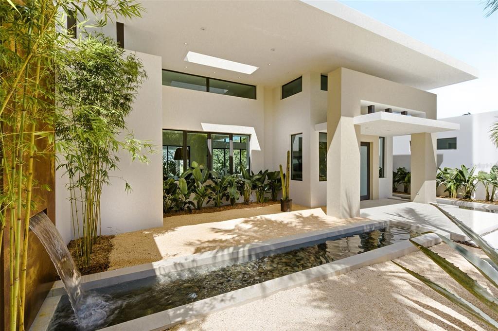 A modern courtyard features a water feature, bamboo, a gravel bed, and a skylight — 11 GOLF VIEW DRIVE, DORADO, PR