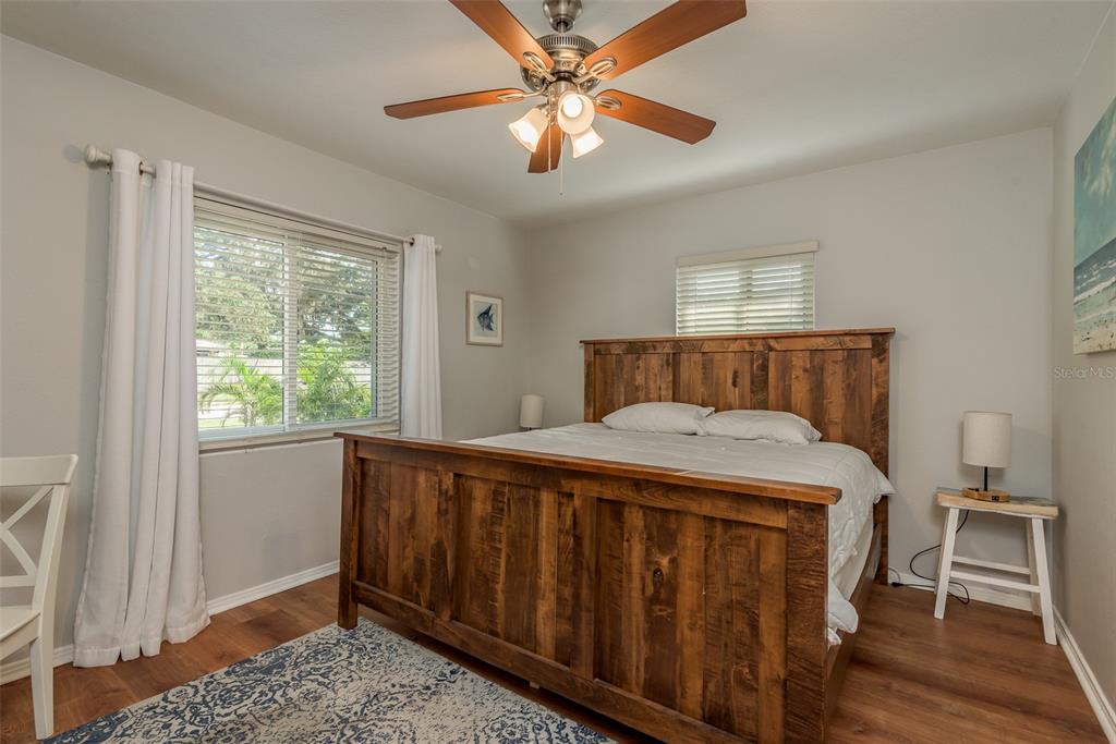 A bedroom features a wooden bed frame, a ceiling fan, and a patterned area rug — 1253 UNION STREET, CLEARWATER, FL