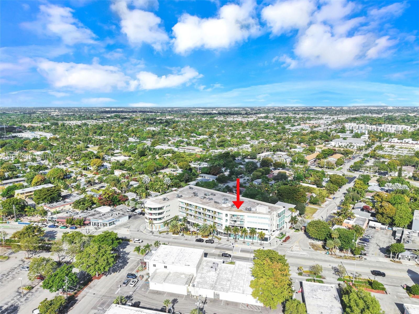 An aerial view shows a multi-story commercial building with a red arrow pointing toward it — 2301 Wilton Dr # C5, Wilton Manors FL 33305, WILTON MANORS, FL