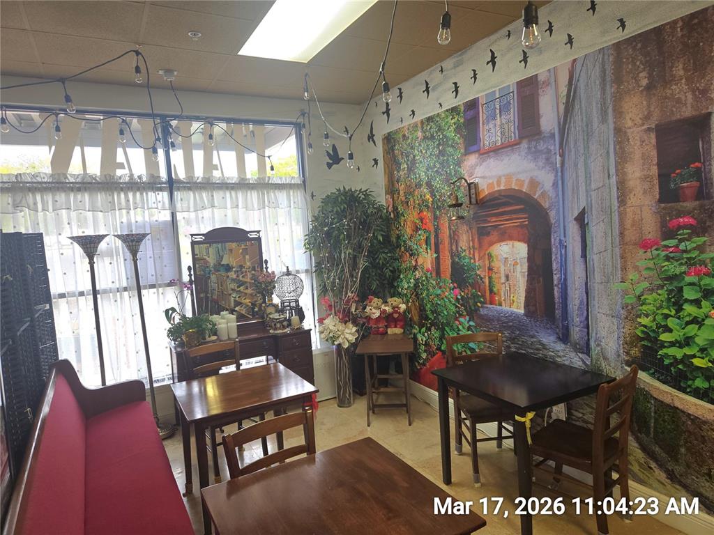 A small dining area features wooden tables, chairs, a red bench, and a mural wall — 0000 BRANDON BOULEVARD, BRANDON, FL