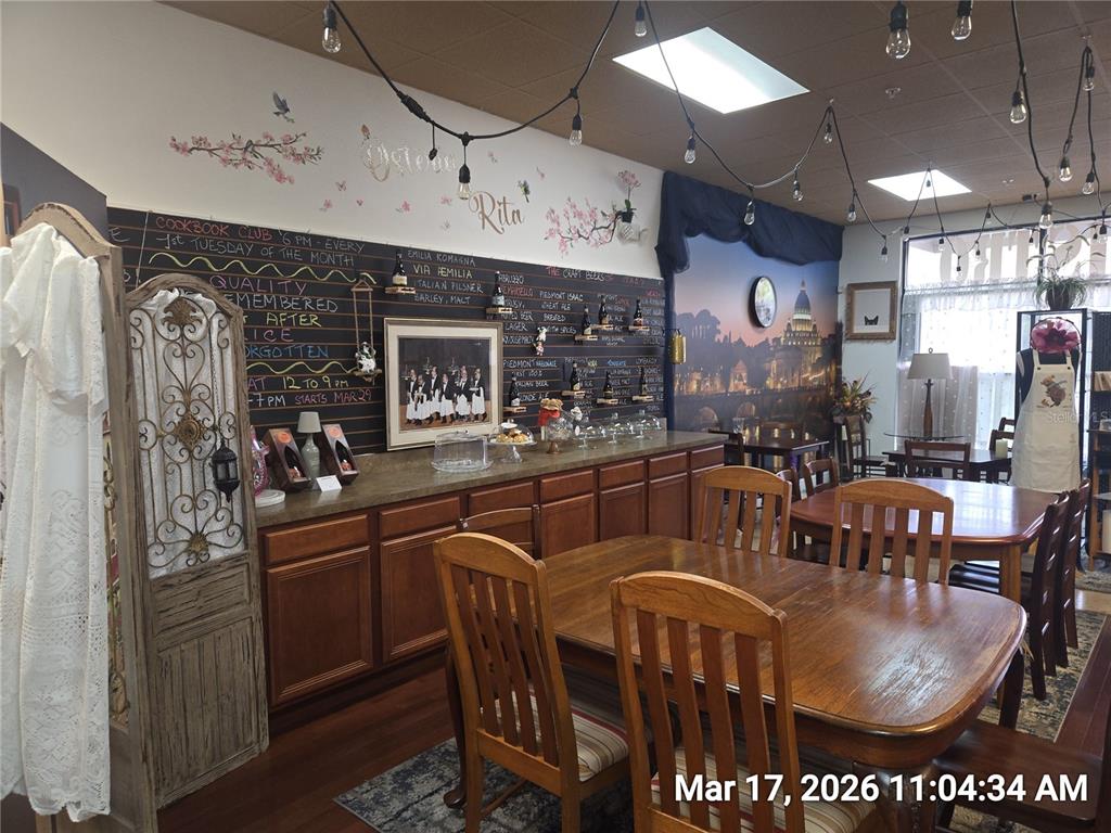 A dining area features wooden tables and chairs, a chalkboard menu, and string lighting — 0000 BRANDON BOULEVARD, BRANDON, FL