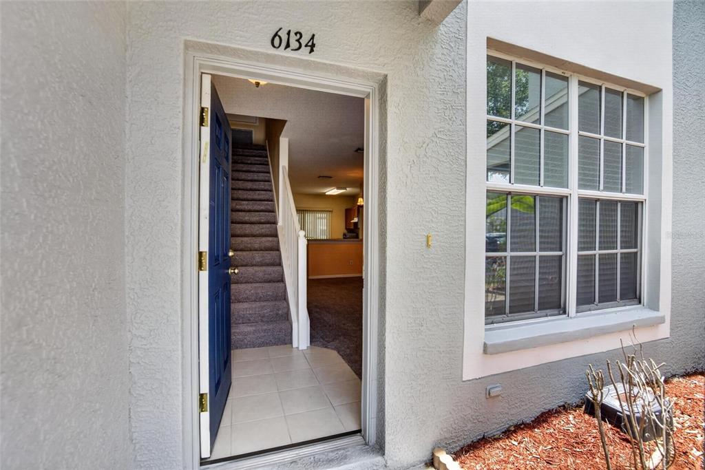 A two-story townhouse exterior at dusk with a parking space marked 6134 in front — 6134 OSPREY LAKE CIRCLE, RIVERVIEW, FL