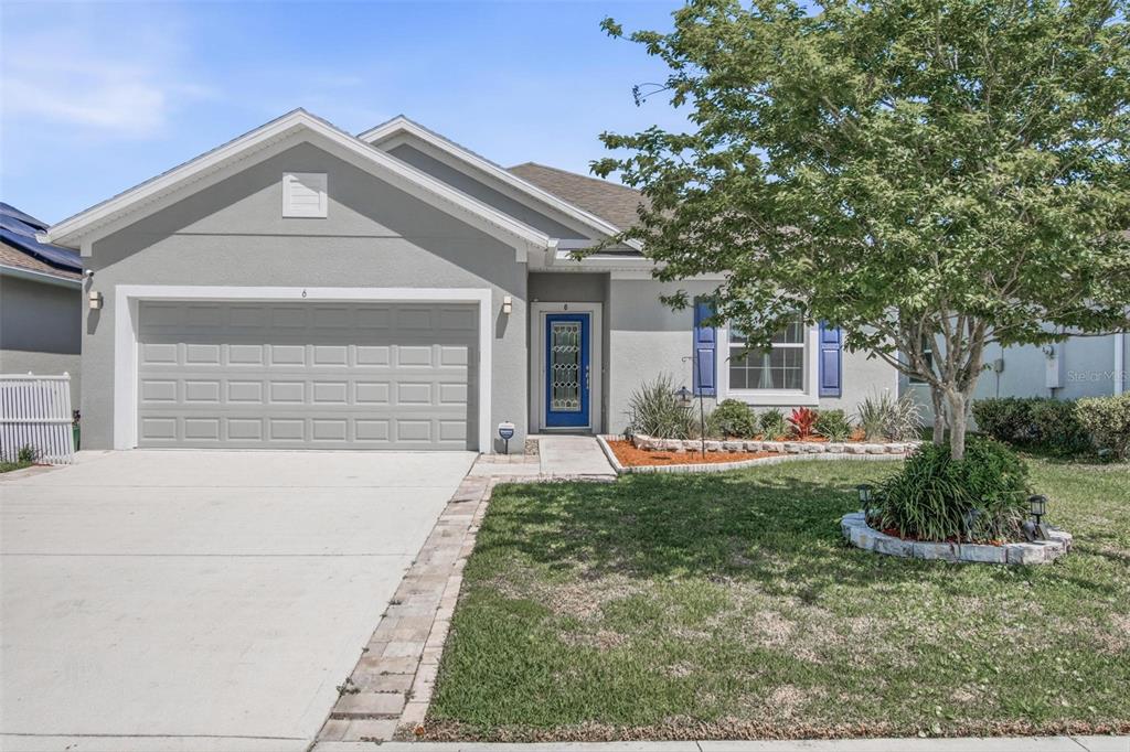 A single-story house with a gray exterior, a two-car garage, and a blue front door — 6 OAKLEAF WAY, PALM COAST, FL