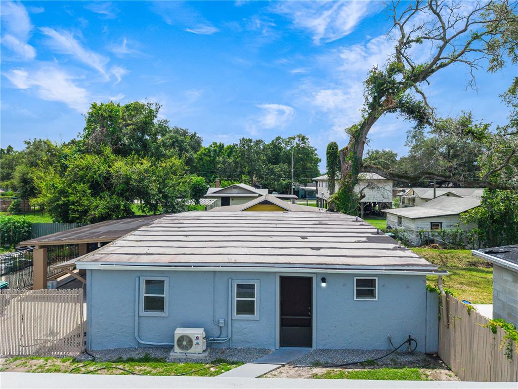 A light blue, single-story house exterior with a flat roof and a window air conditioner — 910 18TH STREET, ORLANDO, FL