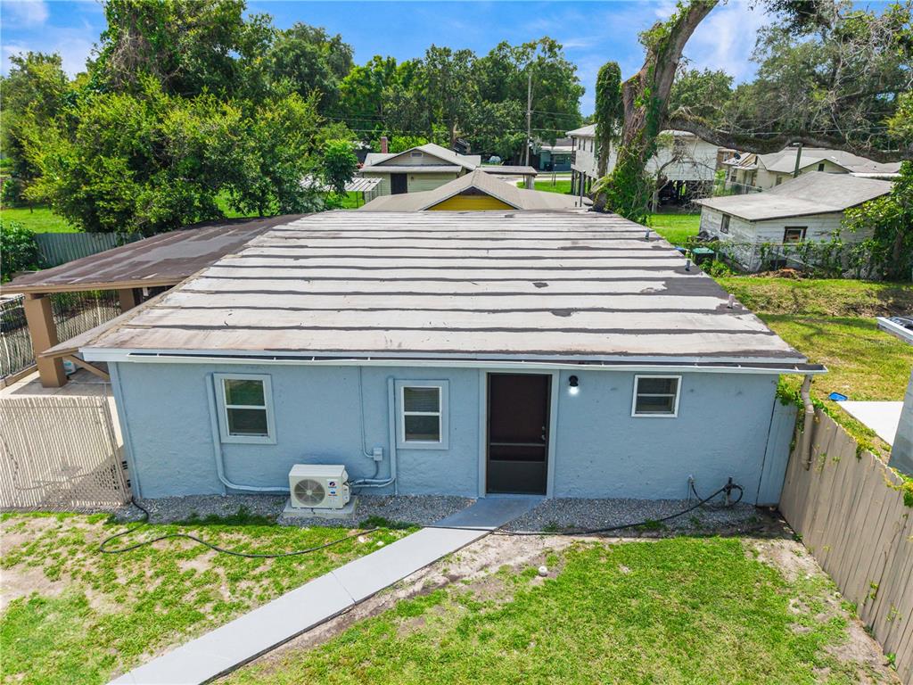 An exterior view of the back of a light blue house with a flat roof — 910 18TH STREET, ORLANDO, FL
