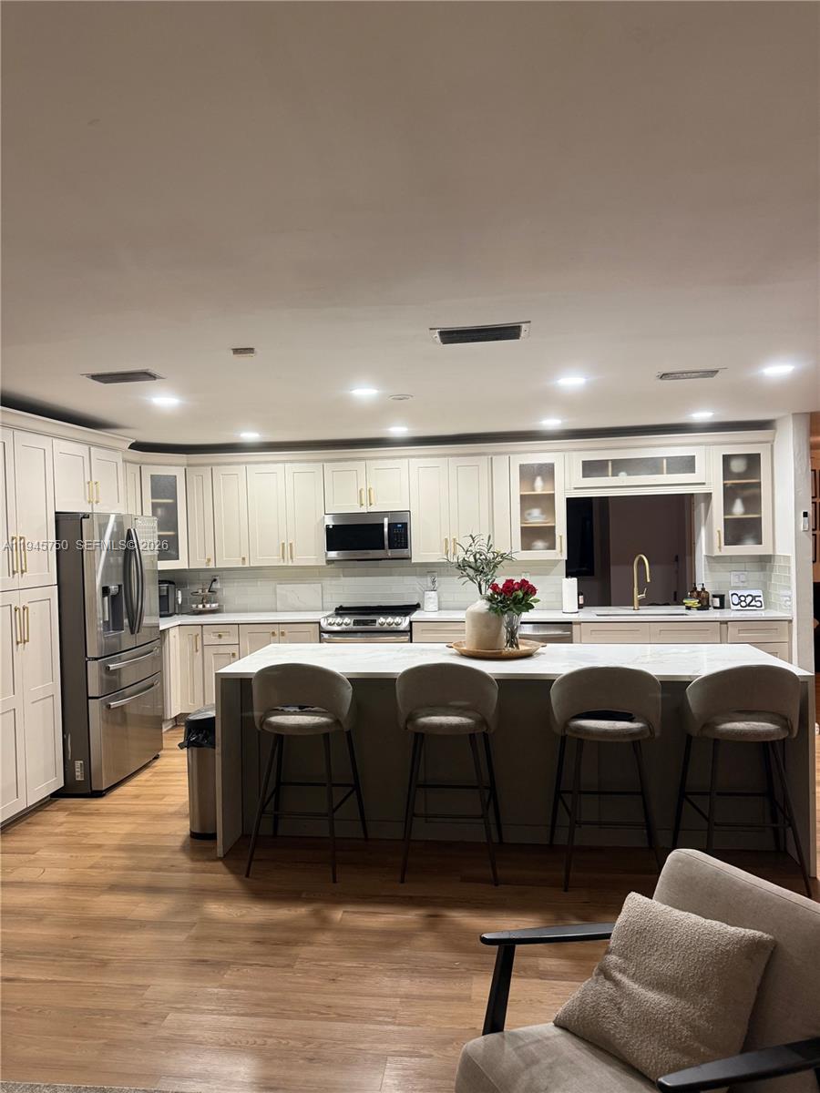 A dining room features a dark wood table, black chairs, and a decorative glass chandelier — 7770 NW 45th Ct, Lauderhill FL 33351, LAUDERHILL, FL
