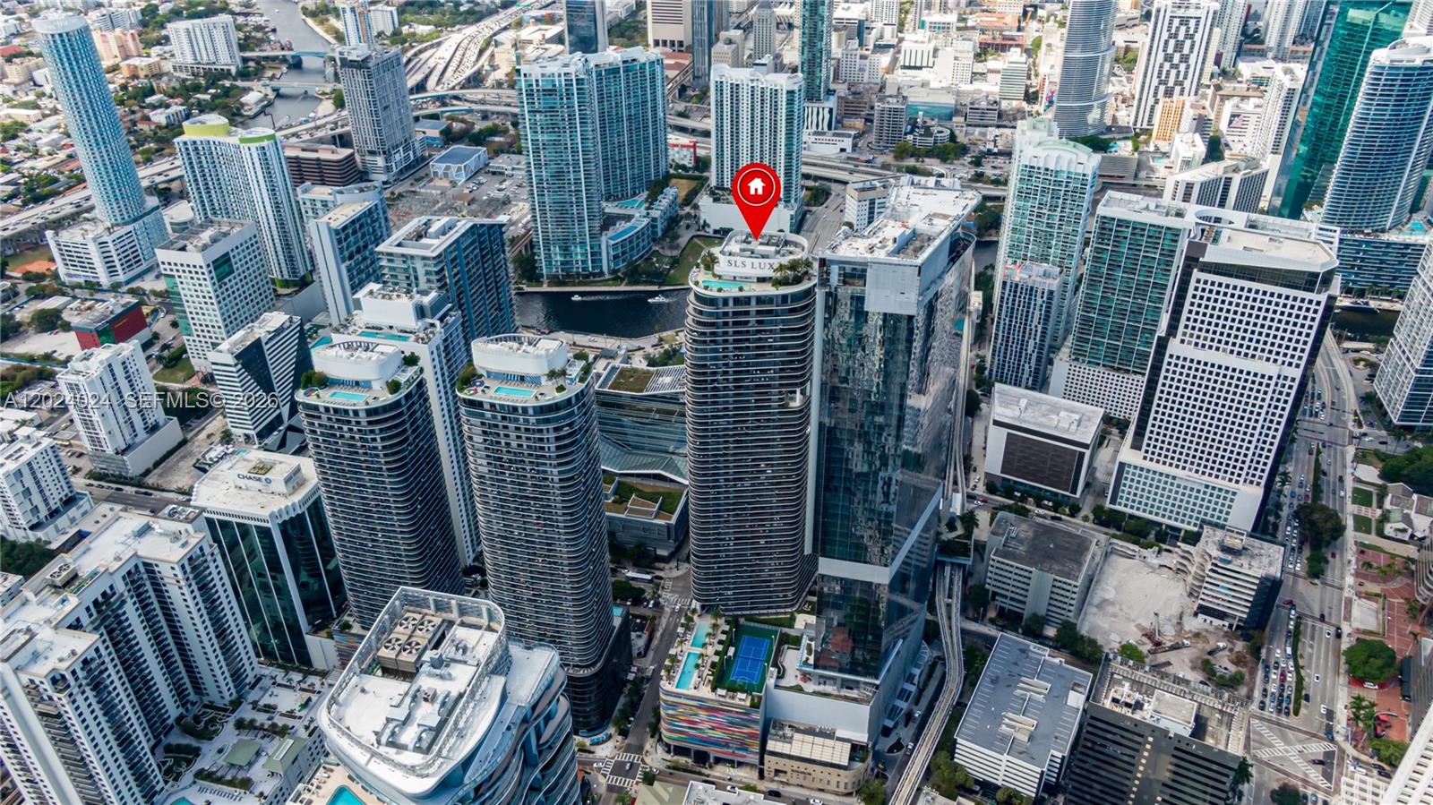 An aerial view shows the SLS LUX Brickell tower in Miami with a red location pin — 801 S Miami Ave # 4405, Miami FL 33130, MIAMI, FL