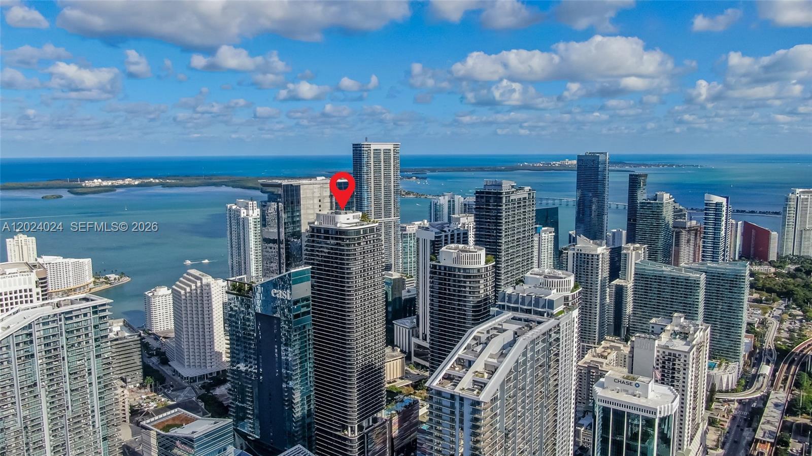 An aerial view shows a dense cluster of high-rise skyscrapers in a coastal city — 801 S Miami Ave # 4405, Miami FL 33130, MIAMI, FL