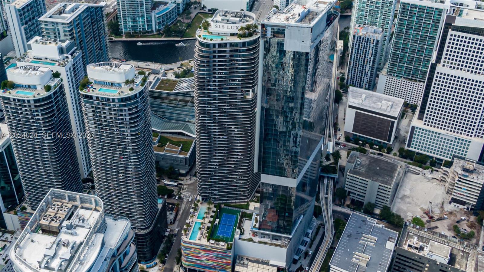 An aerial view of high-rise residential buildings in an urban setting with rooftop pools — 801 S Miami Ave # 4405, Miami FL 33130, MIAMI, FL