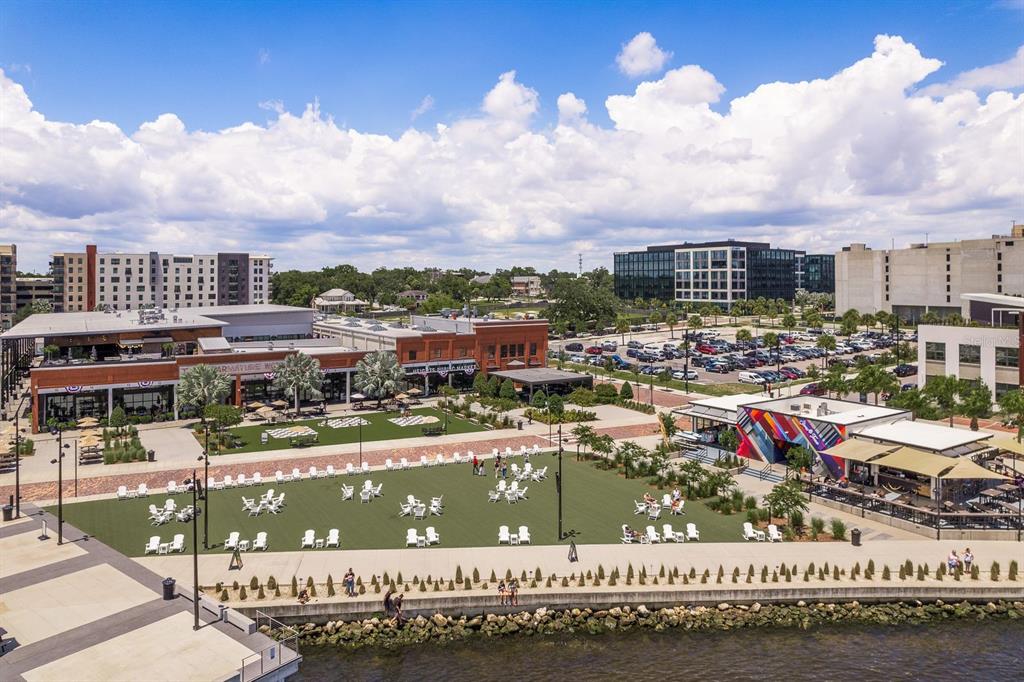 An aerial view of a waterfront park with lawn chairs, a market building, and parking — 2119 N OLA AVENUE UNIT 2, TAMPA, FL