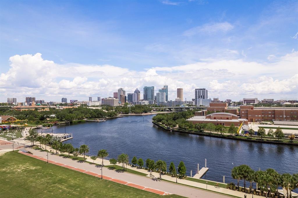 An elevated view of a riverfront park with a city skyline in the background — 2119 N OLA AVENUE UNIT 2, TAMPA, FL
