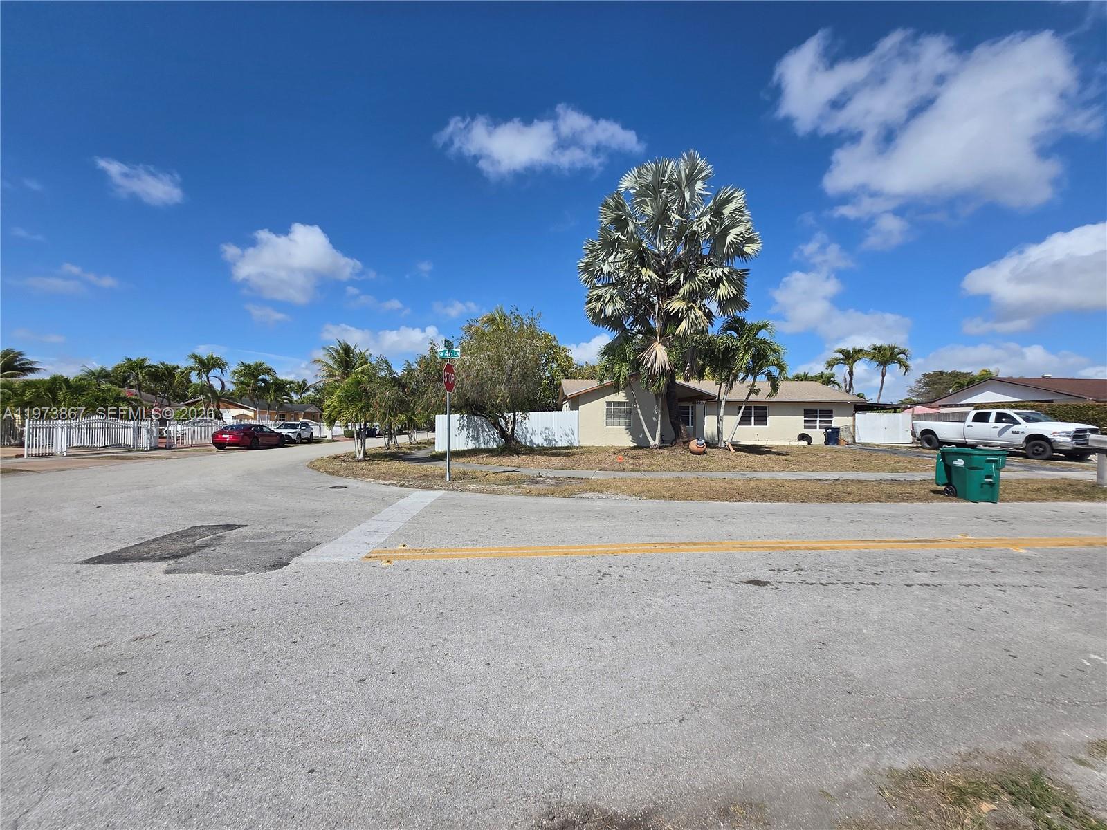 A street view shows a single-story house with a large palm tree and a white fence — 13377 SW 46th Ln, Miami FL 33175, MIAMI, FL