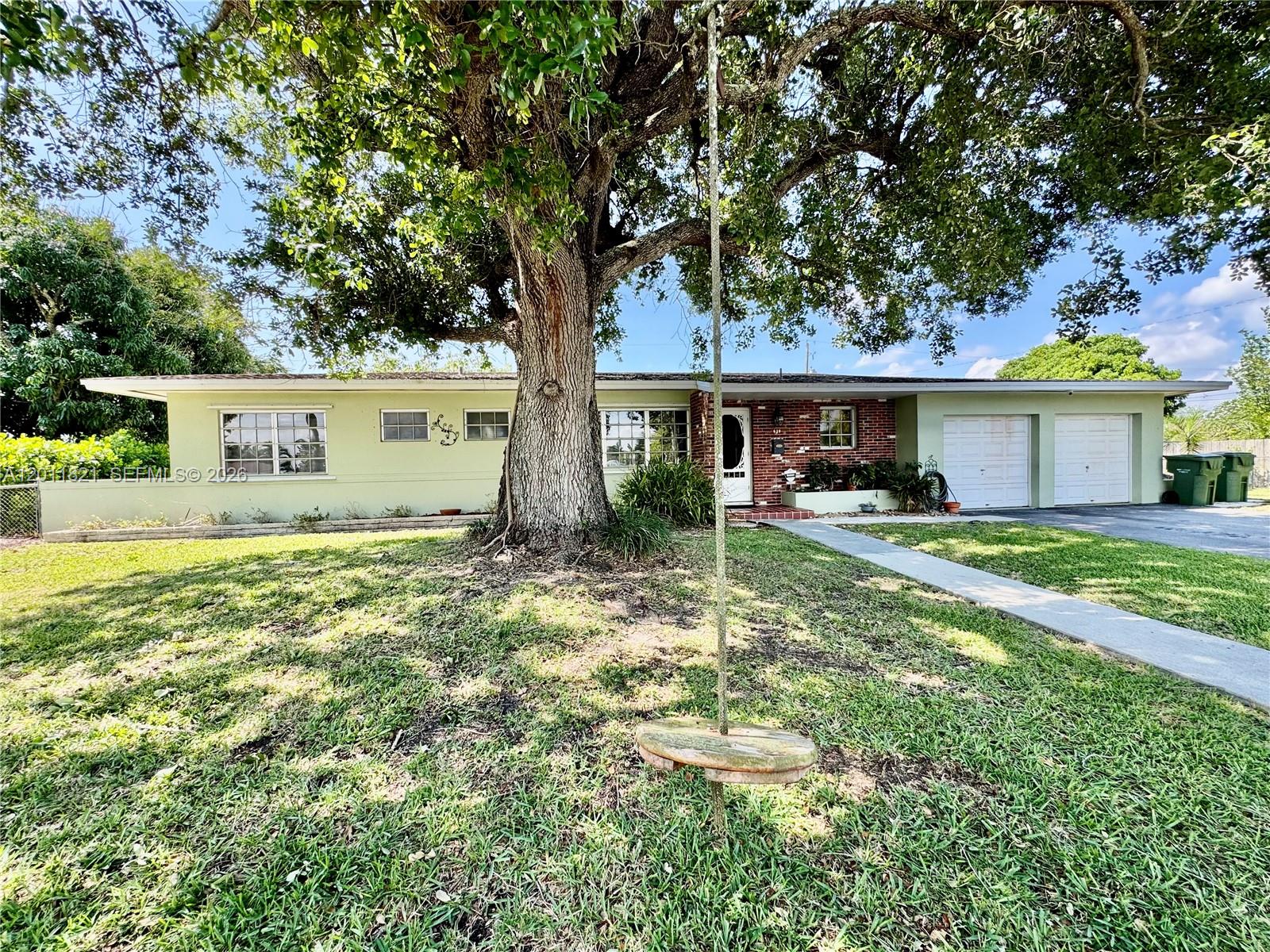 A single-story house with a large tree and a rope swing in the front yard — 434 NW 20th St, Homestead FL 33030, HOMESTEAD, FL