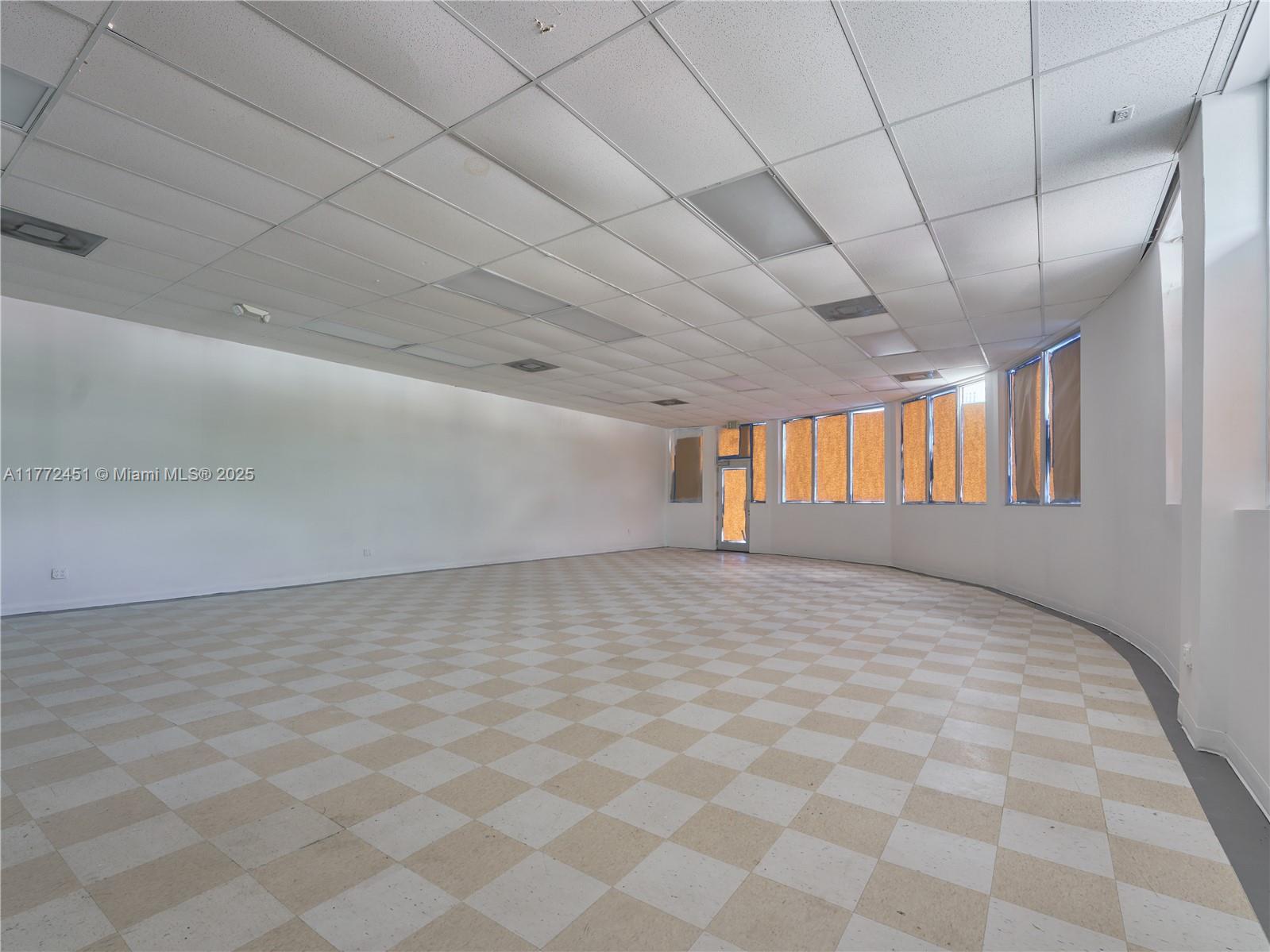 An empty commercial space features a checkered tile floor, white walls, and a drop ceiling — 6211 NW 7th Ave # 75, Miami FL 33150, MIAMI, FL