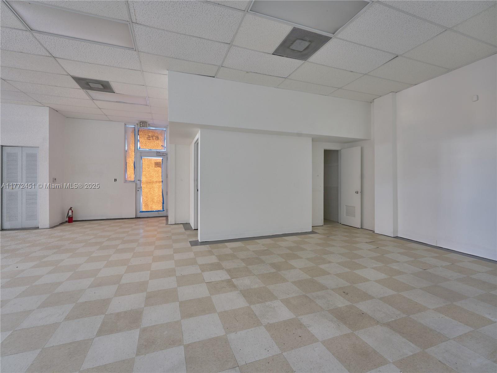 An empty commercial space features a checkered tile floor, white walls, and a drop ceiling — 6211 NW 7th Ave # 75, Miami FL 33150, MIAMI, FL