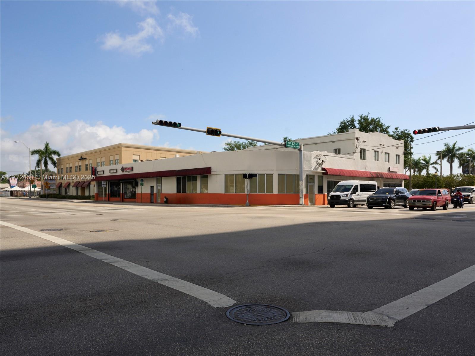 A low-rise commercial building with an orange base sits at a street intersection — 6211 NW 7th Ave # 75, Miami FL 33150, MIAMI, FL