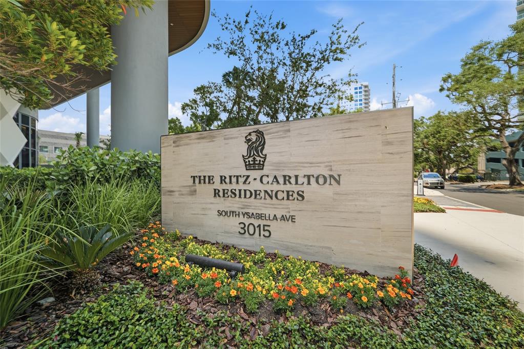 A stone sign for The Ritz-Carlton Residences stands in a landscaped garden bed — 3015 S YSABELLA AVENUE UNIT 2102, TAMPA, FL
