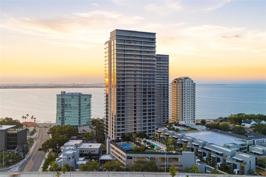 An aerial view of high-rise apartment buildings situated along a waterfront at sunset — 3015 S YSABELLA AVENUE UNIT 2102, TAMPA, FL