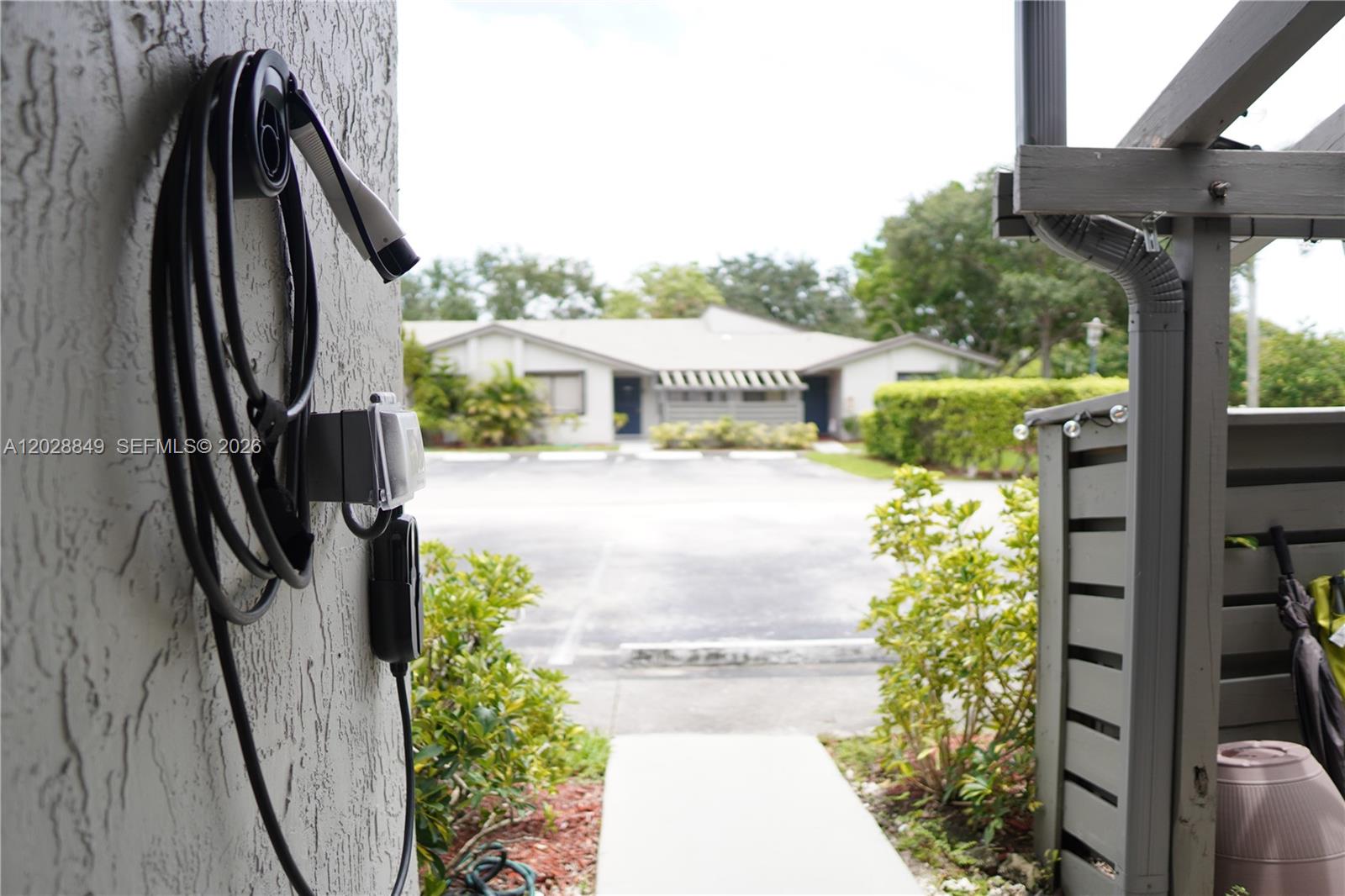 An electric vehicle charging station is mounted on the exterior wall of a building — 453 Lakeview Dr # 2, Weston FL 33326, WESTON, FL