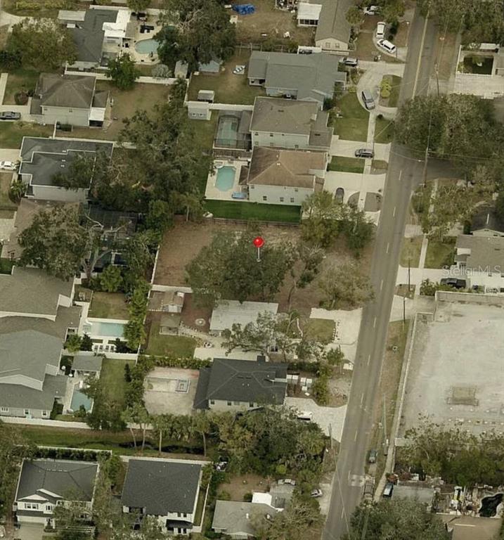 An aerial view shows a residential lot with trees and a small structure — 2405 S LOIS AVENUE, TAMPA, FL