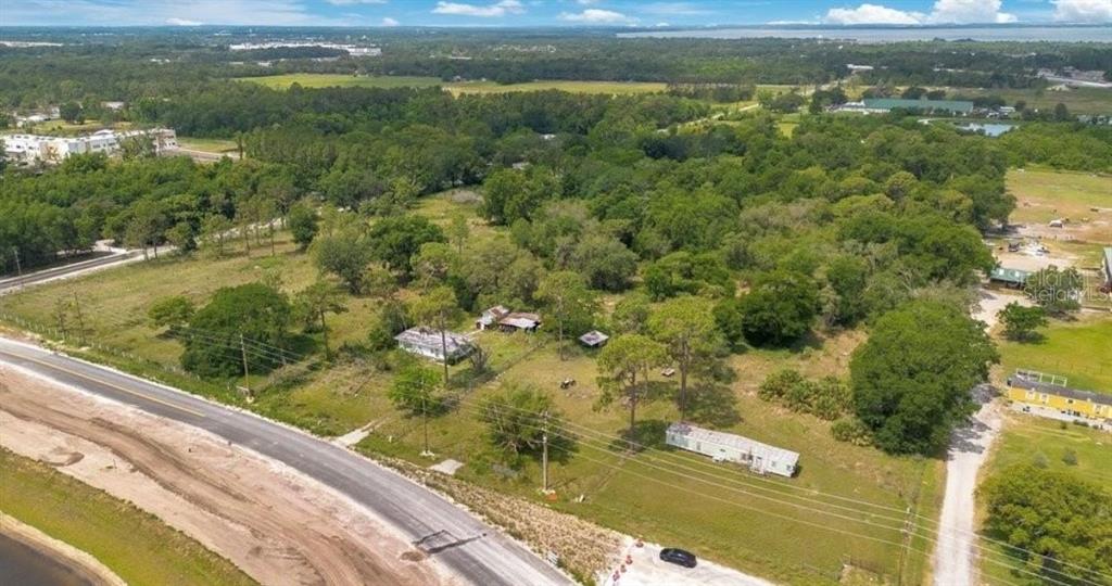 An aerial view shows a rural property with several small buildings and a mobile home — 1938 N LAKEWOOD AVENUE, OCOEE, FL