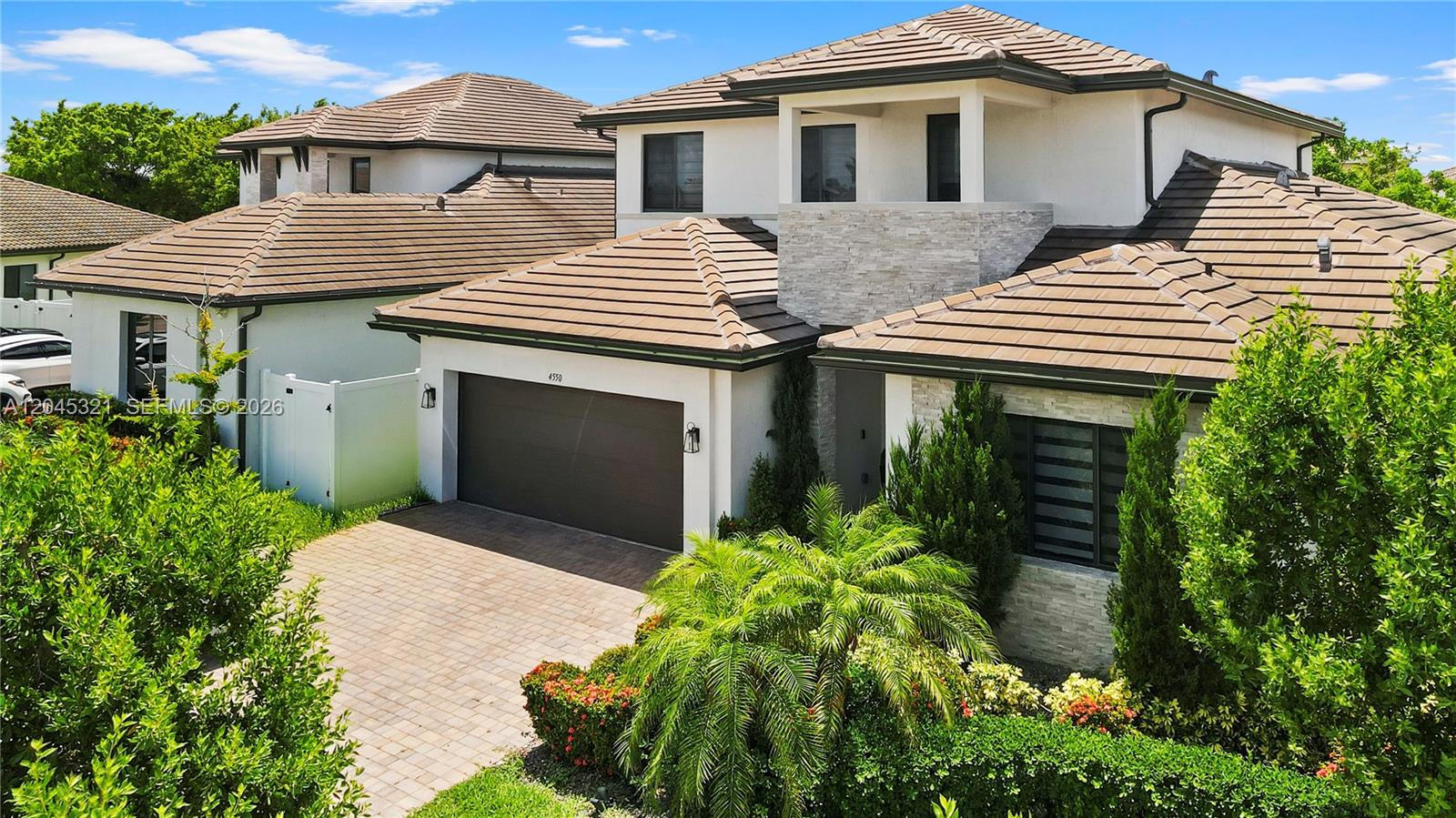 A two-story house with a brown tile roof, white stucco walls, and a paved driveway — 4550 SW 178th Ave, Miramar FL 33029, MIRAMAR, FL