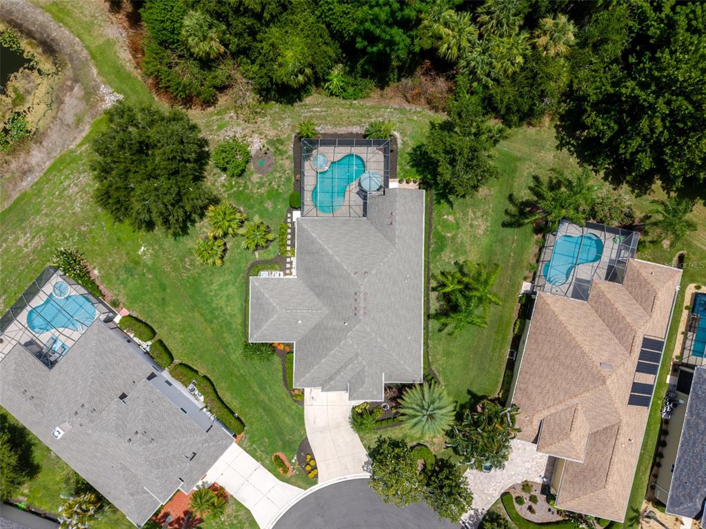 A single-story suburban house with a two-car garage, palm trees, and a concrete driveway — 12344 LAVENDER LOOP, BRADENTON, FL