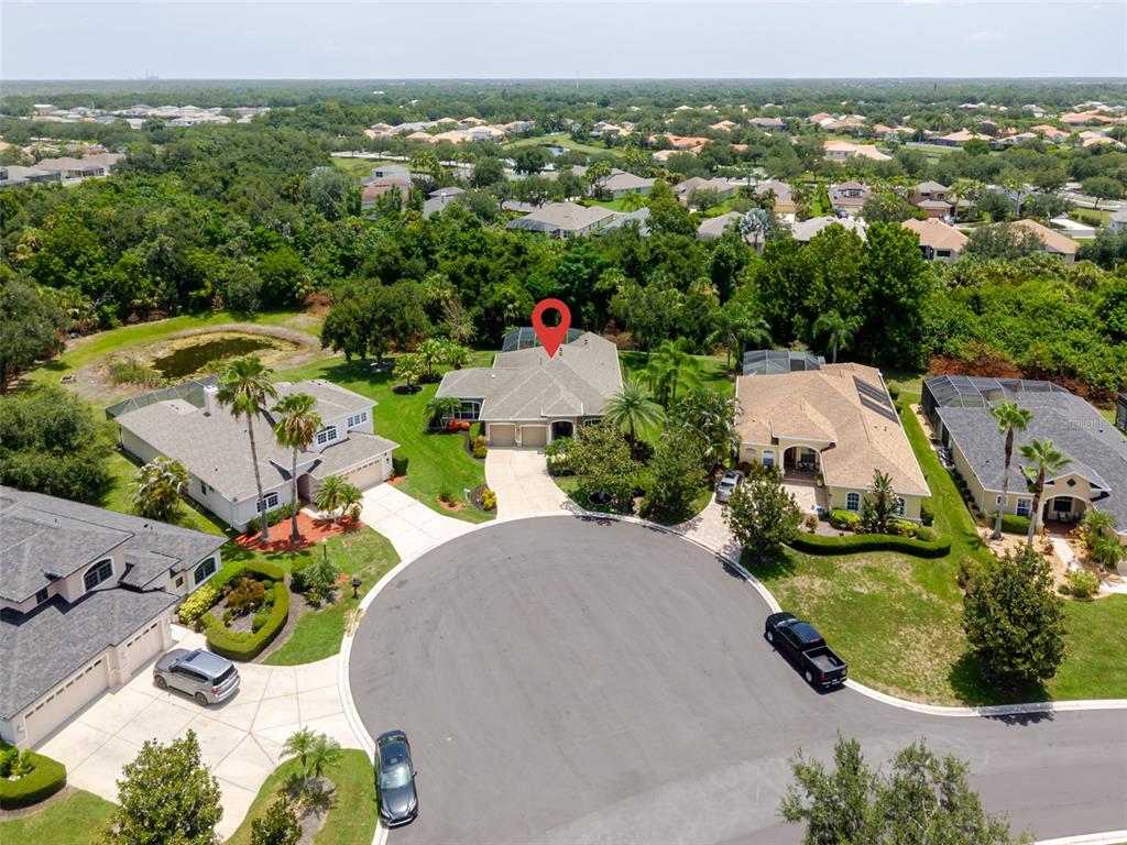 An aerial view shows a suburban cul-de-sac with several houses and a red location pin — 12344 LAVENDER LOOP, BRADENTON, FL