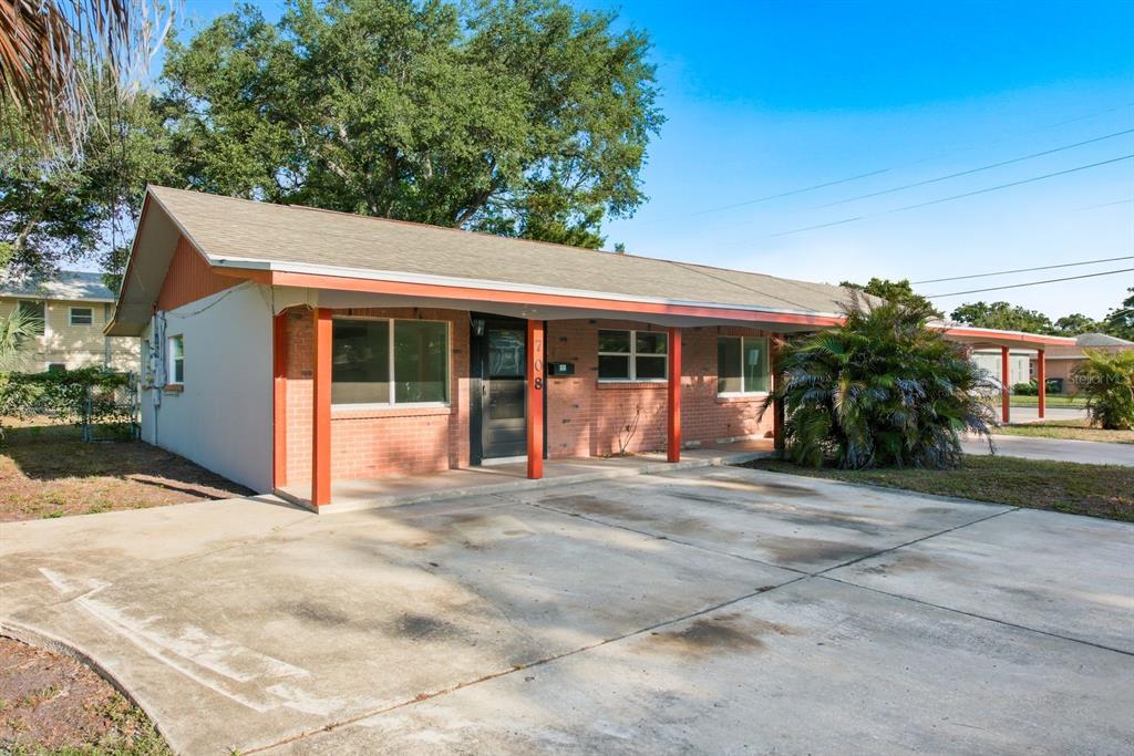 A single-story brick house with a covered porch and a concrete driveway — 708 PENNSYLVANIA AVENUE, CLEARWATER, FL