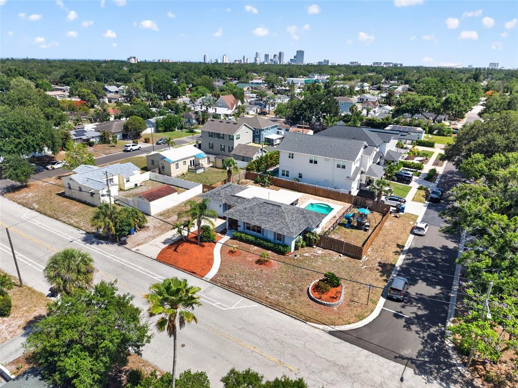 An aerial view shows a residential neighborhood with a house featuring a backyard swimming pool — 1674 34TH AVENUE N, ST PETERSBURG, FL