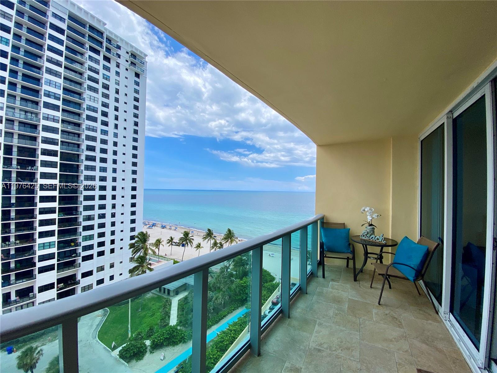 A balcony with tile flooring, patio furniture, and a view of the ocean and beach — 2501 S Ocean Dr # 1104, Hollywood FL 33019, HOLLYWOOD, FL
