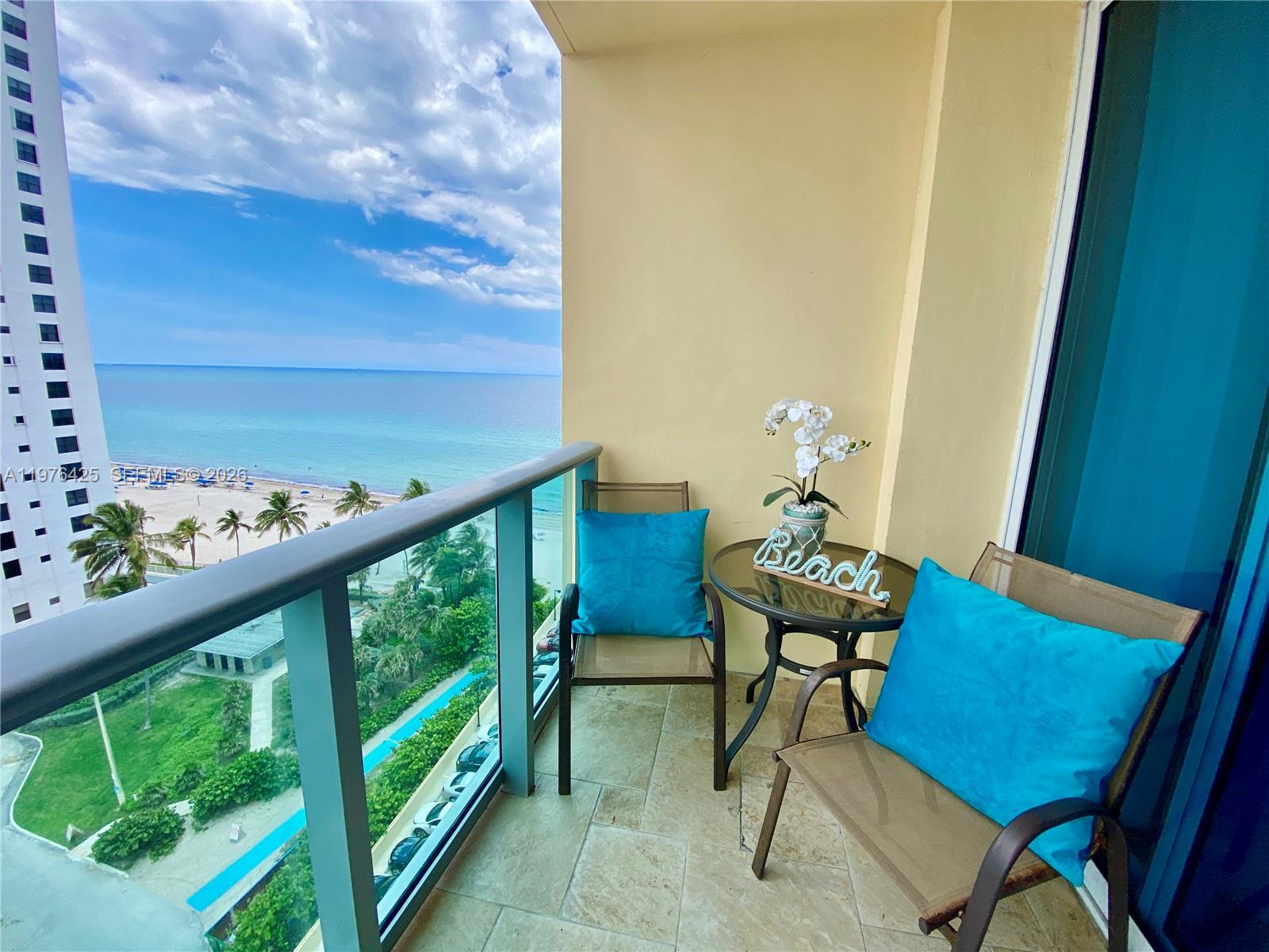 A balcony with two chairs, a small table, and a view of the ocean — 2501 S Ocean Dr # 1104, Hollywood FL 33019, HOLLYWOOD, FL