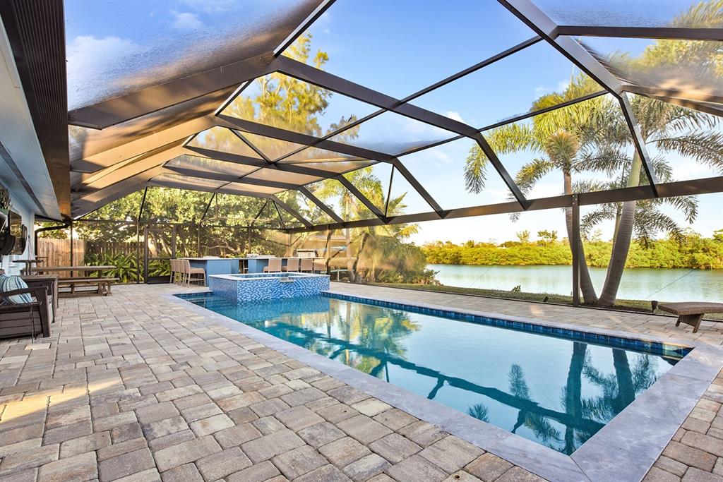 An aerial view shows a waterfront property outlined in yellow with a house and dock — 300 E BAY HEIGHTS AVENUE, ENGLEWOOD, FL