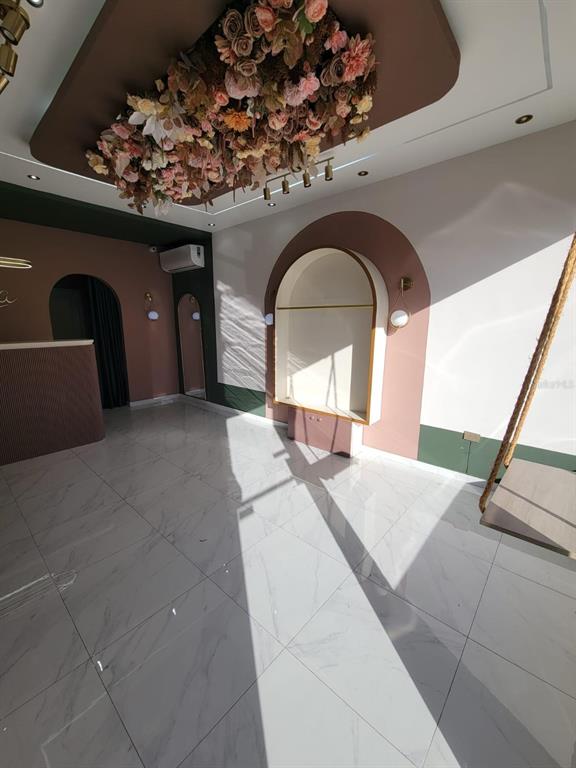 A modern room features a floral ceiling installation, arched wall niches, and white marble flooring — BB 29 AVE SANTA JUANITA, BAYAMON, PR