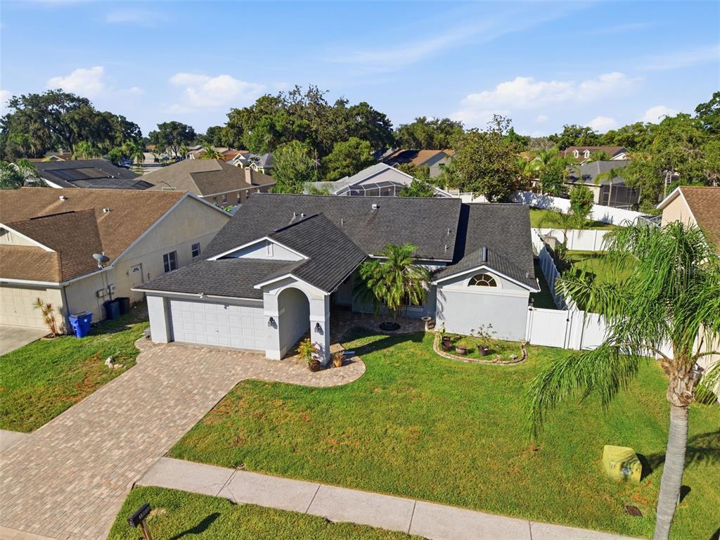 An aerial view of a single-story house with a gray roof and a paved driveway — 10050 HERMOSILLO DRIVE, NEW PORT RICHEY, FL