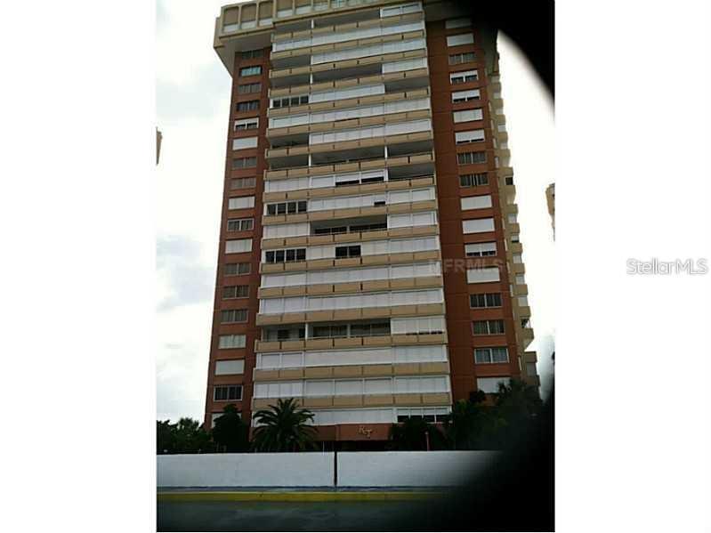 A tall, multi-story residential apartment building with balconies and a brown exterior facade — 17920 GULF BOULEVARD UNIT 1203, ST PETERSBURG, FL
