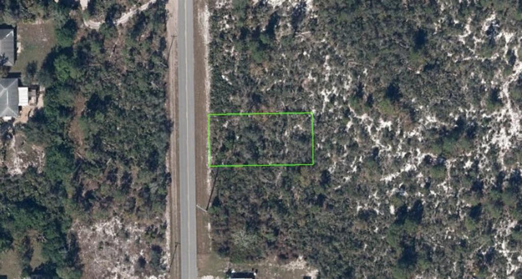 An aerial view of a rectangular plot of land outlined in green next to a road — 411 HALLMARK AVENUE, LAKE PLACID, FL