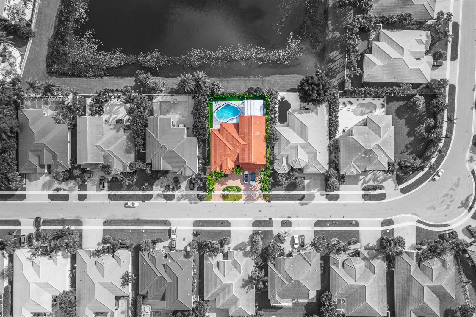 An aerial view shows a house with an orange roof and pool near a lake — 11804 Osprey Pointe Circle, Wellington FL 33449, WELLINGTON, FL