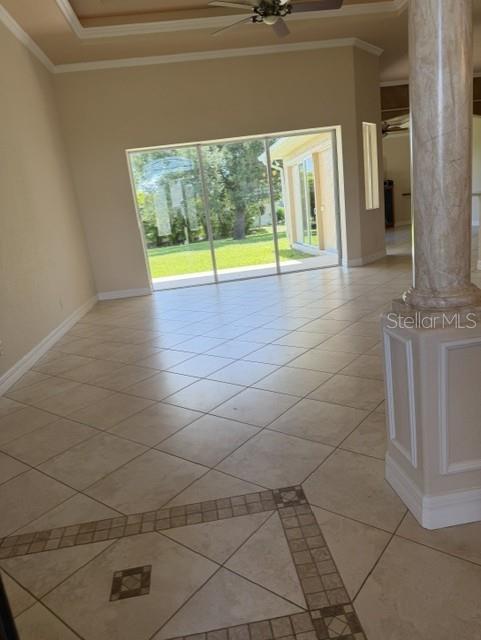 A room with beige tile flooring, a decorative border, a ceiling fan, and sliding glass doors — 857 BOUNDARY BOULEVARD, ROTONDA WEST, FL