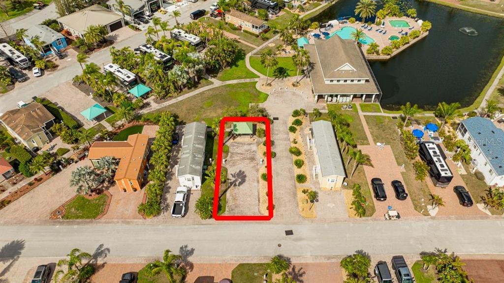 An aerial view shows a vacant, rectangular RV lot outlined in red within a resort community — 6948 AMANDA VISTA CIRCLE, LAND O LAKES, FL