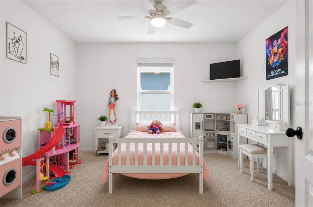 A child's bedroom features a white bed, a dollhouse, a play kitchen, and a vanity — 3155 COUNTRY CLUB CIRCLE, WINTER HAVEN, FL