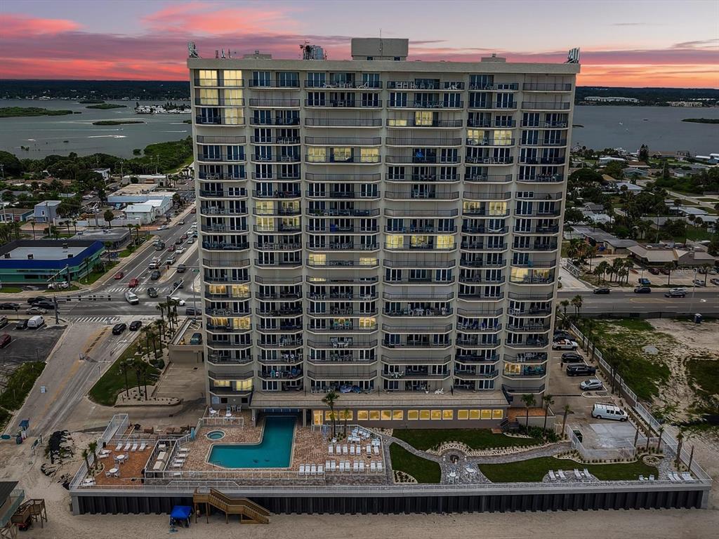 A circular hot tub and a rectangular swimming pool overlook the ocean at sunset — 3425 S ATLANTIC AVENUE UNIT 1105, DAYTONA BEACH SHORES, FL