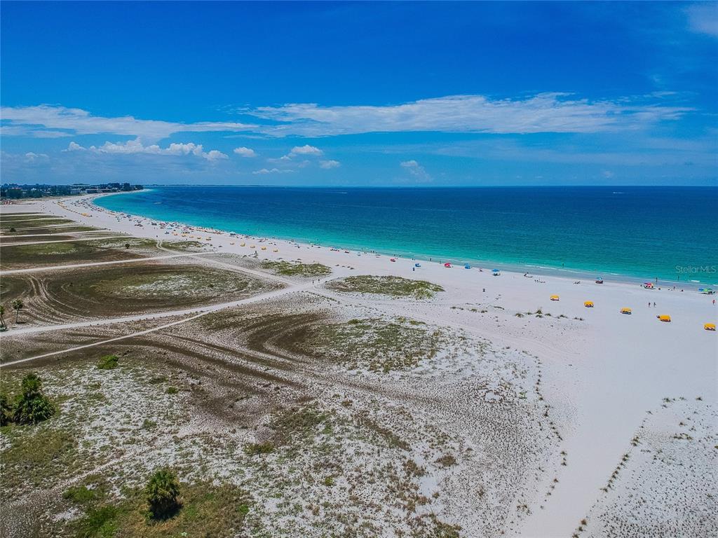 An aerial view of a white sand beach with dunes and the ocean — 11605 GULF BOULEVARD UNIT 502, TREASURE ISLAND, FL