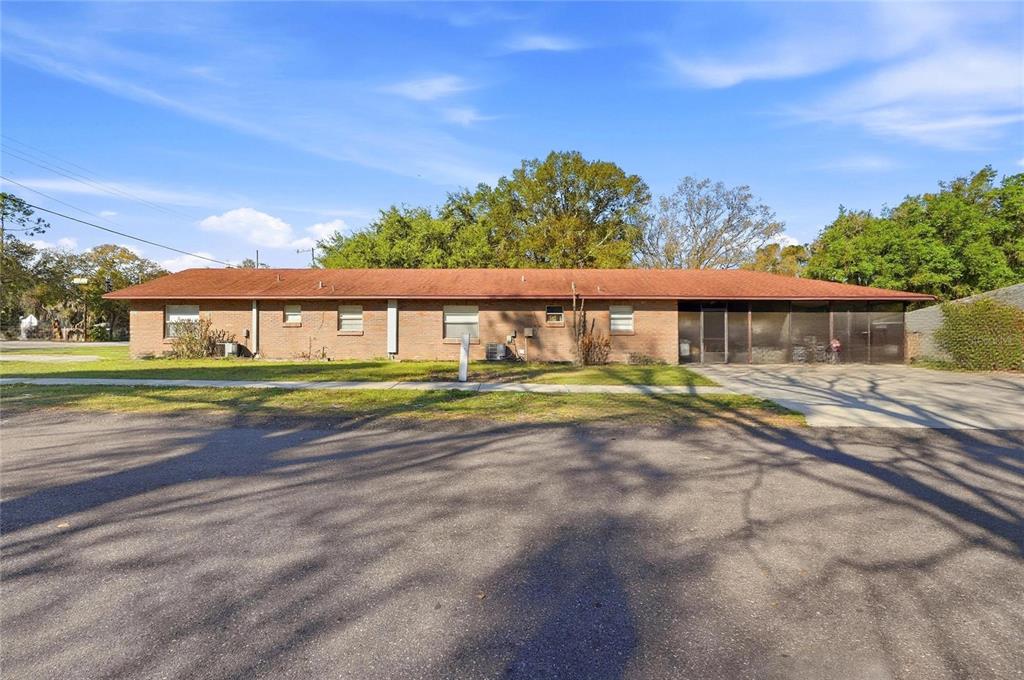 A single-story brick house with a red roof and a screened-in porch — 2300 CANNON TERRACE NW UNIT A,B,C,D,E,F, WINTER HAVEN, FL