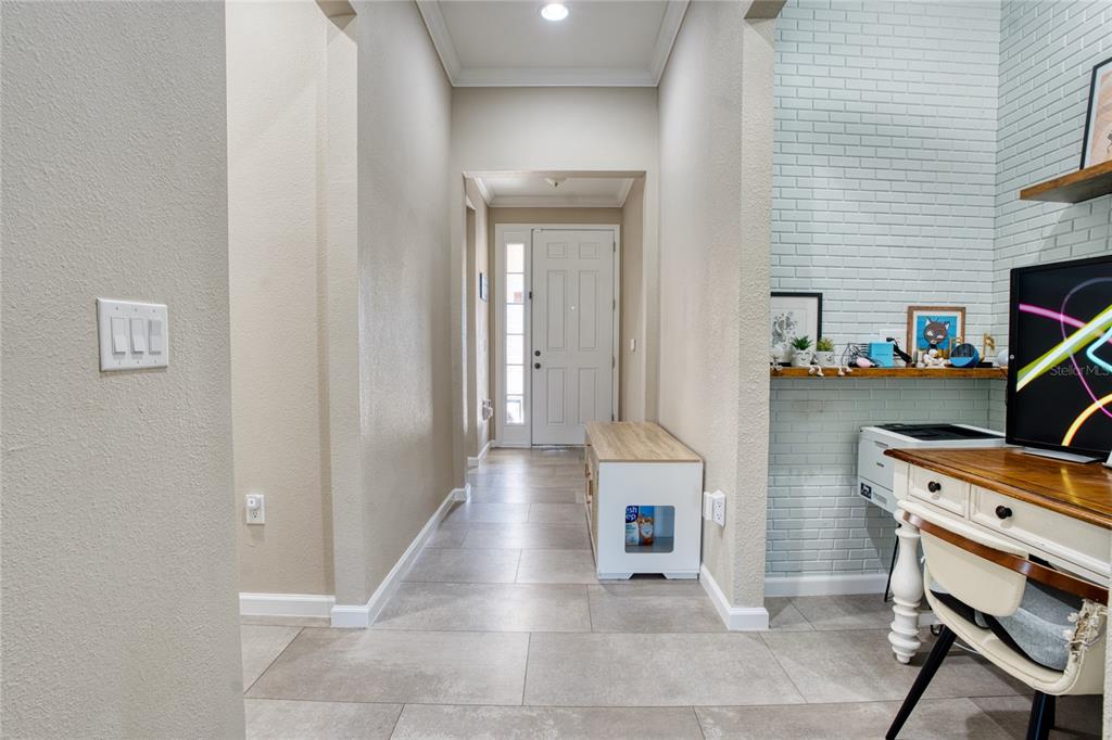 A tiled entryway leads to a white front door, with a desk area on the right — 1608 HIGHBANKS CIRCLE, WINTER GARDEN, FL