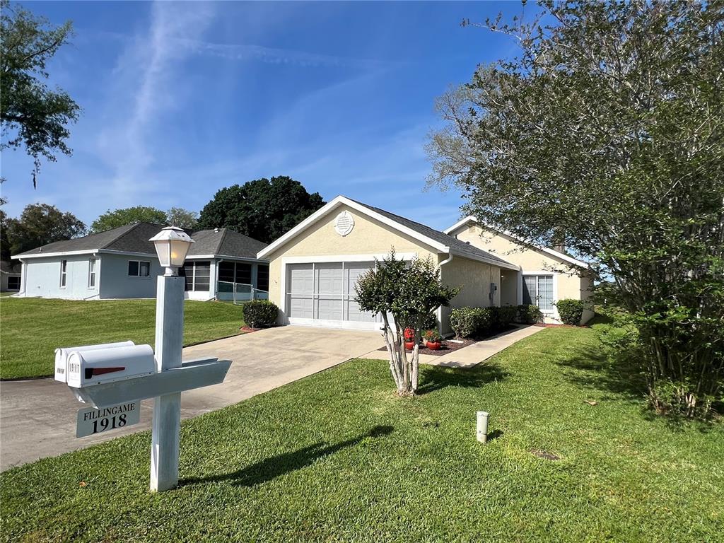 A single-story house with a garage and a mailbox stands on a grassy lawn — 1918 NW 50TH CIRCLE, OCALA, FL