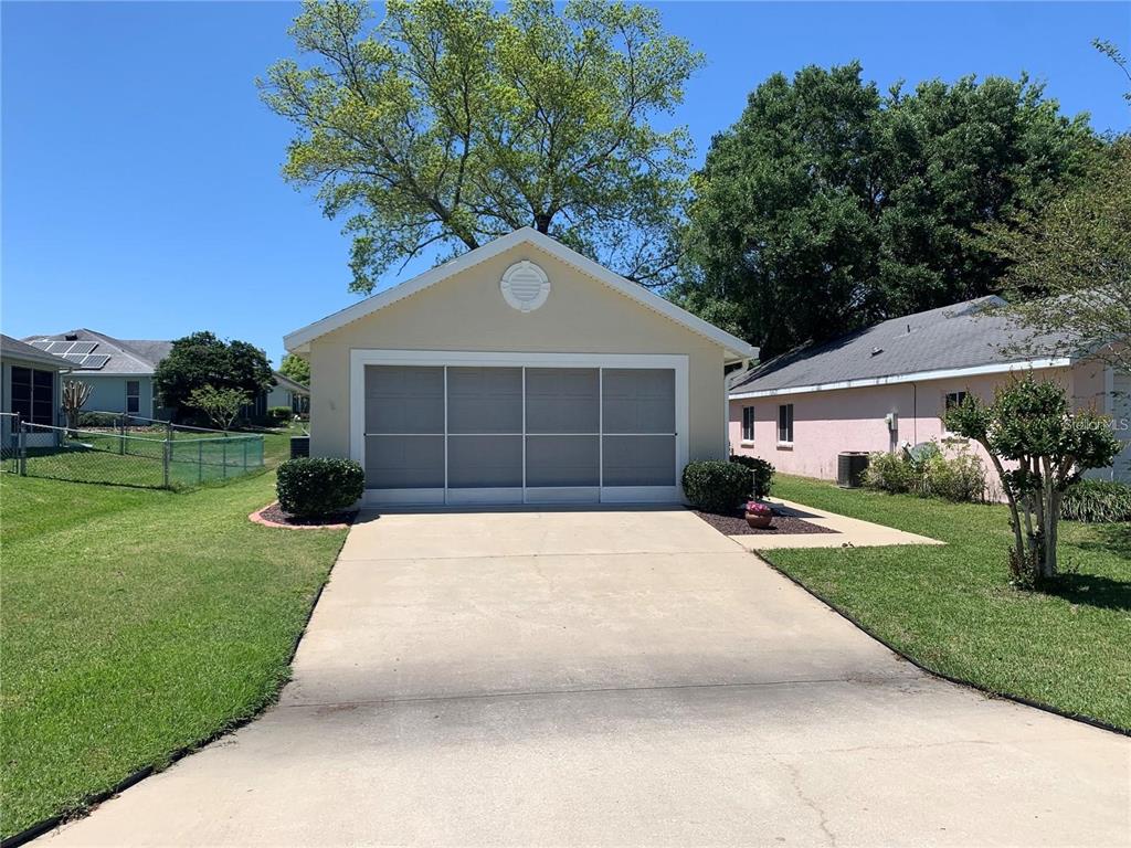 A detached garage with a concrete driveway sits on a grassy residential lot — 1918 NW 50TH CIRCLE, OCALA, FL