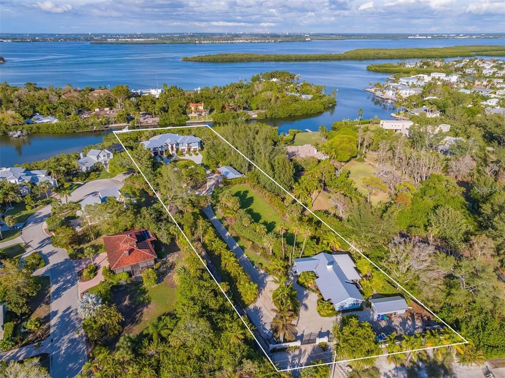 An aerial view shows a large waterfront property with two houses and extensive landscaping — 6680 GULF OF MEXICO DRIVE, LONGBOAT KEY, FL